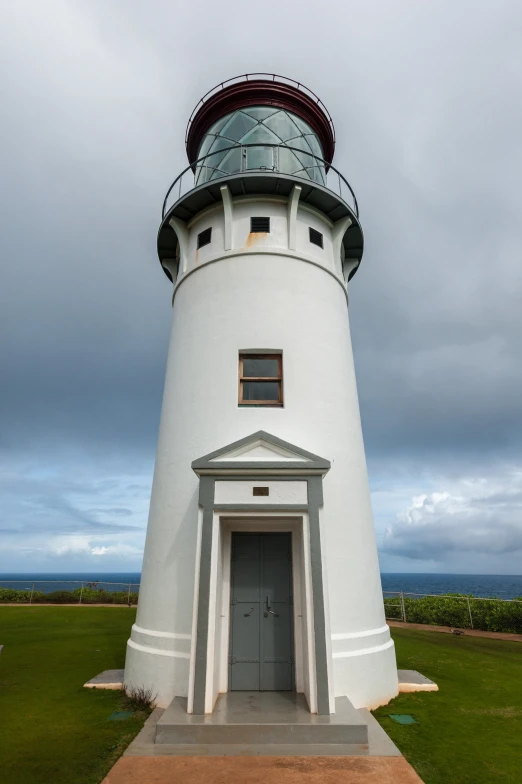 the lighthouse is situated between two small buildings