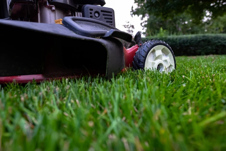 a lawn mower is shown sitting in the grass