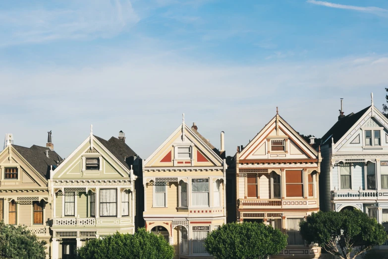 row of multi - colored houses on a sunny day with blue sky