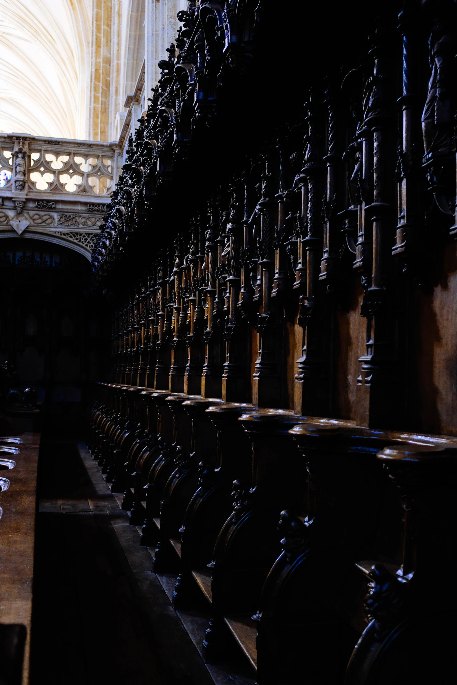 many large wooden benches sit in front of a doorway