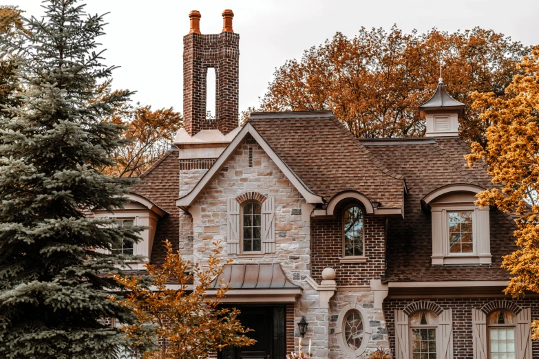 the front of a house with two chimneys on each level