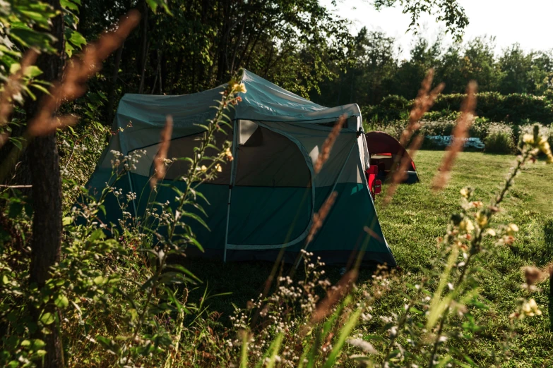 the man is camping out in the woods