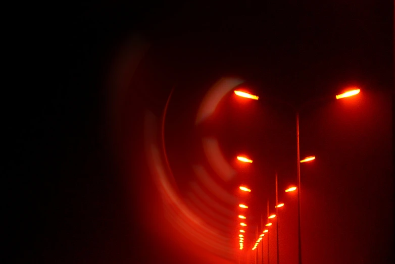 two red streetlights on one pole near a traffic light