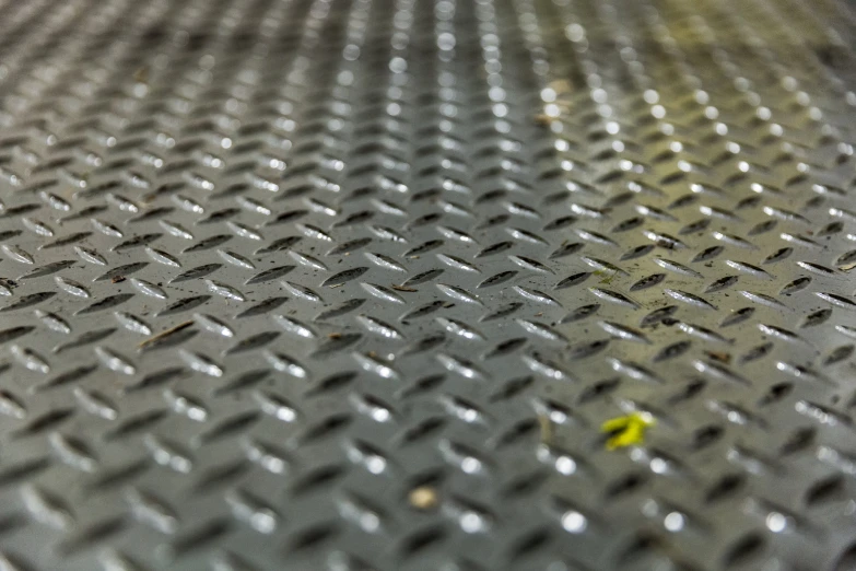 close up of metal floor with yellow flower on it