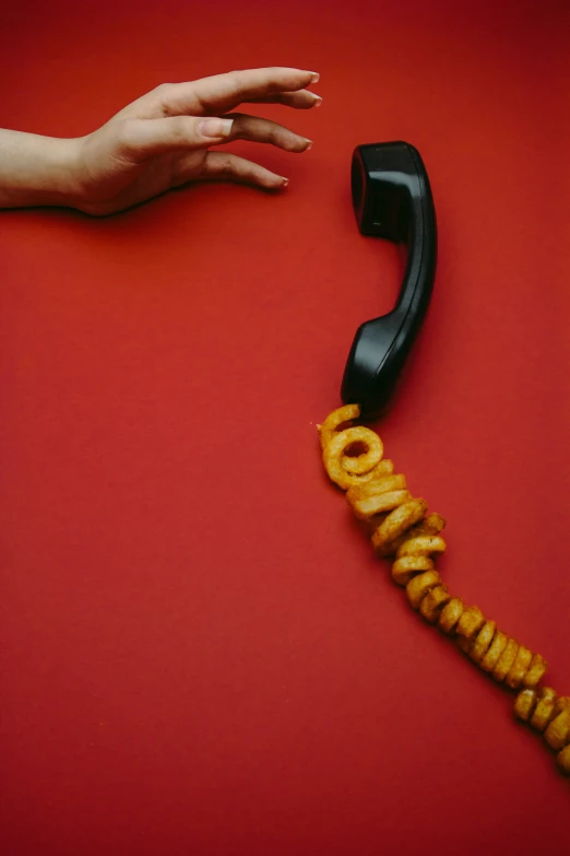 a lady's hand and a black phone are holding on to the phone