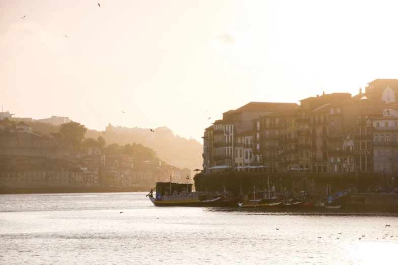 the sun reflects off of the buildings and a river below