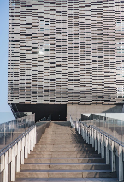 a group of stairs with a modern building in the background