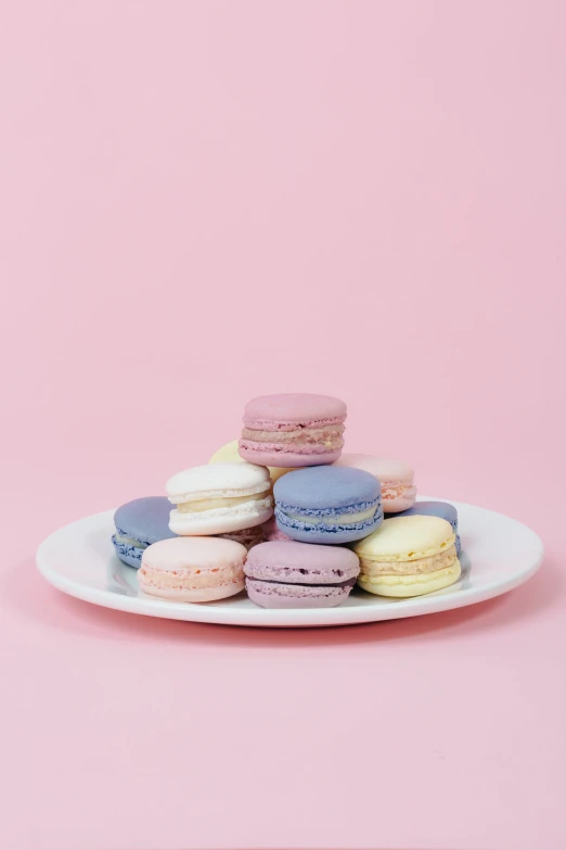 there are some colorful macaroons on a plate