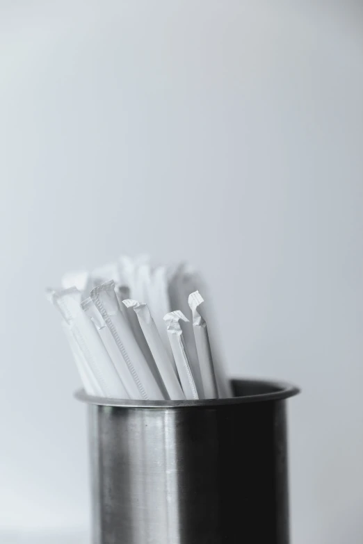 three toothbrushes sitting in a container on a table