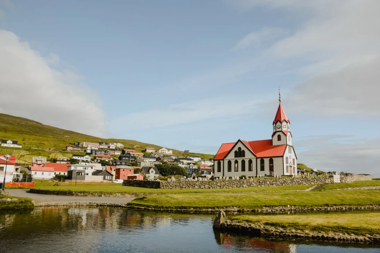 a small village with a lake and water in front