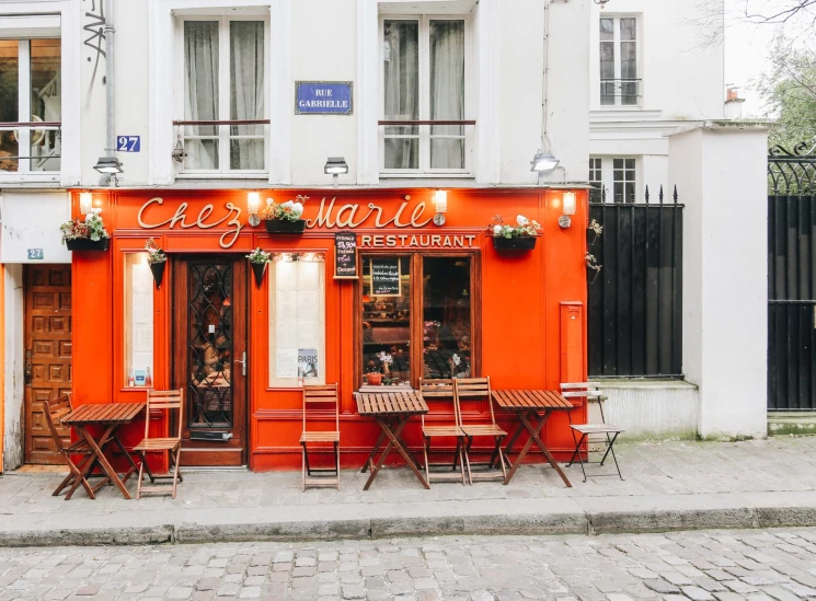 three tables and two chairs outside of a restaurant