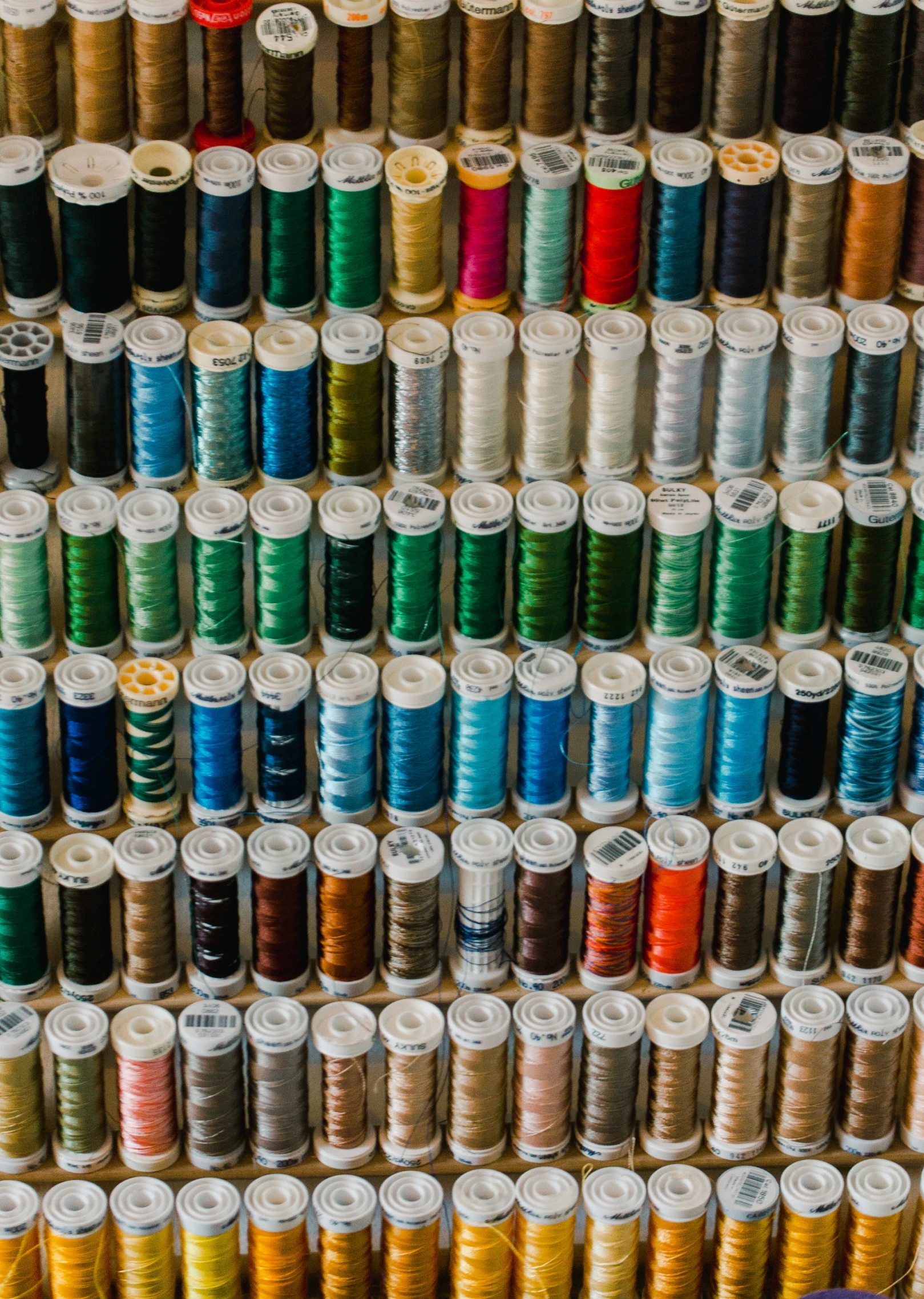 rows of spools of thread on display in an antique store