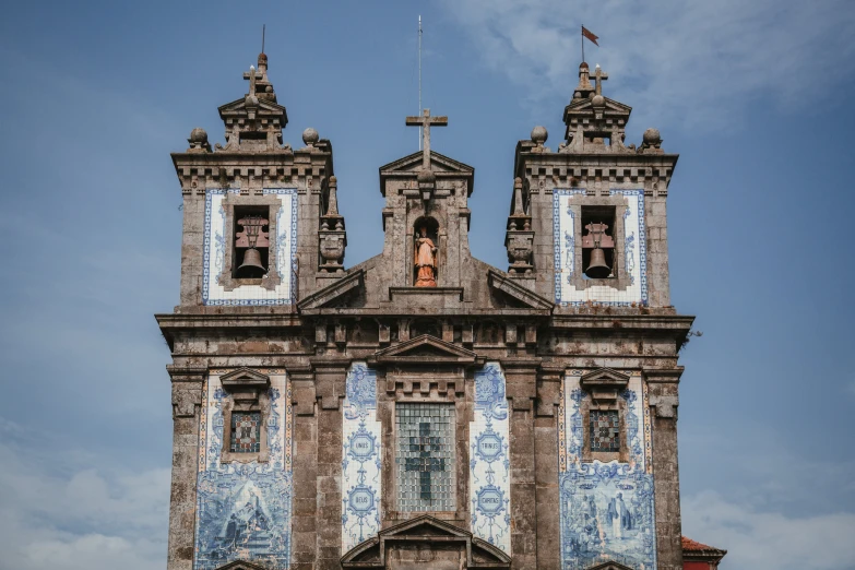 an old building has two tall towers that are painted blue