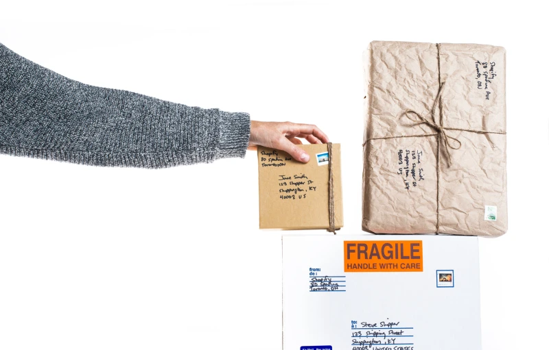 a person is handing a parcel with a hand