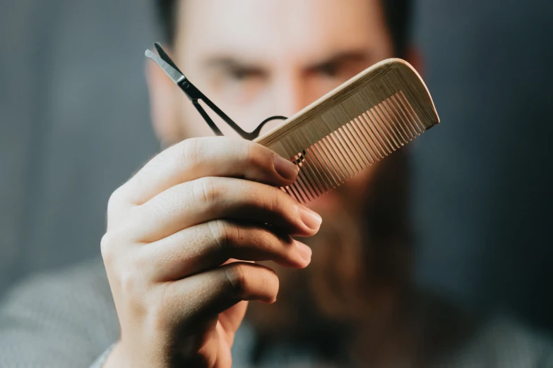 a man with a comb and scissors in his hands