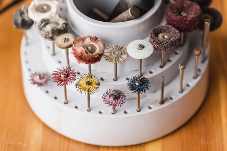 a collection of pins and needles are displayed on a white board