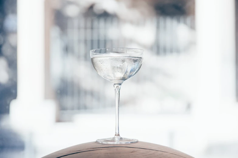 a martini glass on top of a wooden table