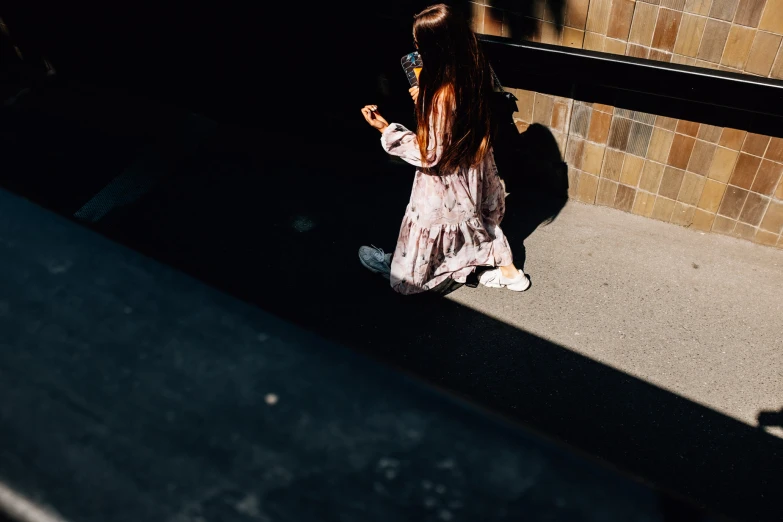 a little girl is sitting down talking on her phone