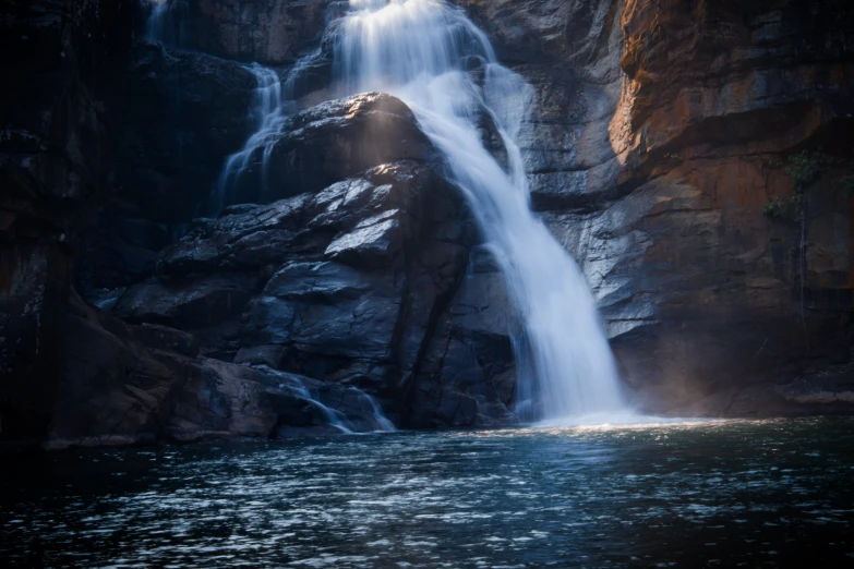 a waterfall in the middle of rocks that have been falling