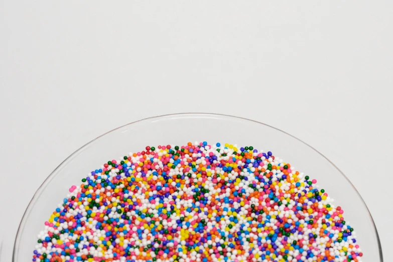 some sprinkles are arranged on a glass bowl