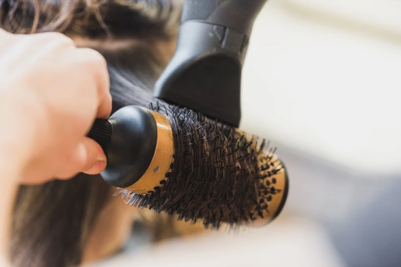 a woman's head in a room with brush