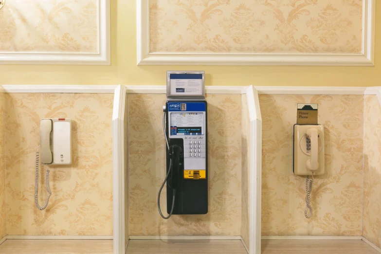 a phone and some wall mounted phones against a wall