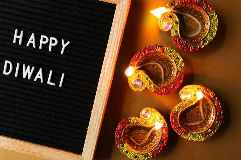 small light lamps next to an happy diwali sign