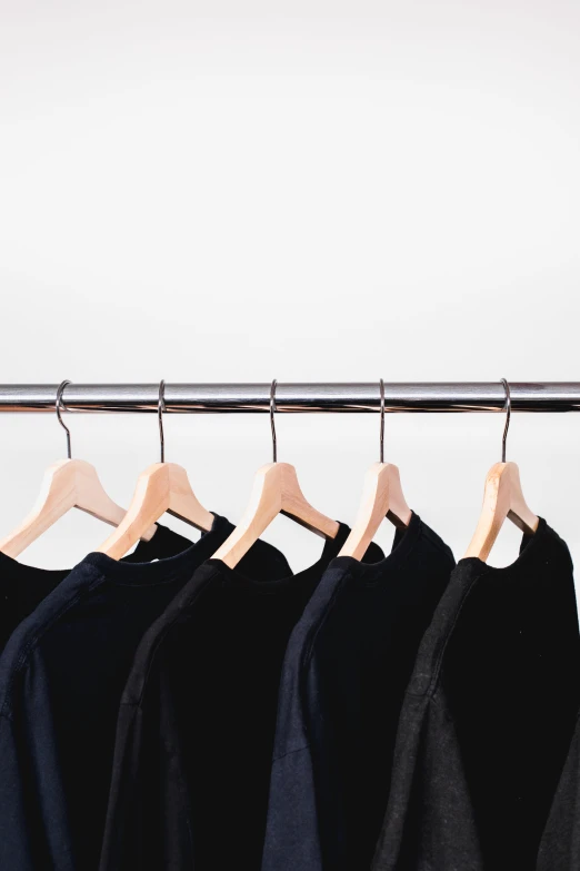 an old fashioned row of shirt hangers showing different colors and styles