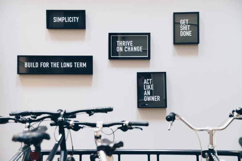 several signs are displayed on the wall of a bike garage