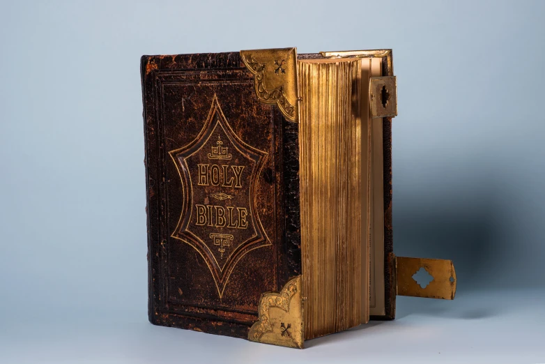 an old book with golden bindings on it