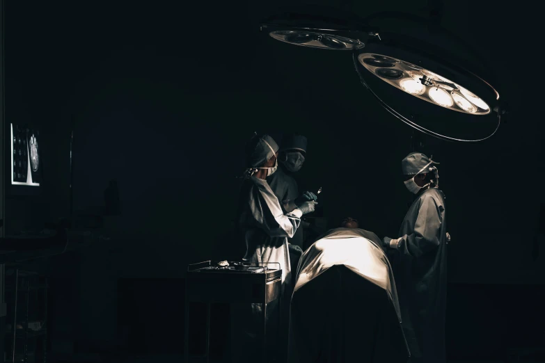 two doctors are performing  in the dark