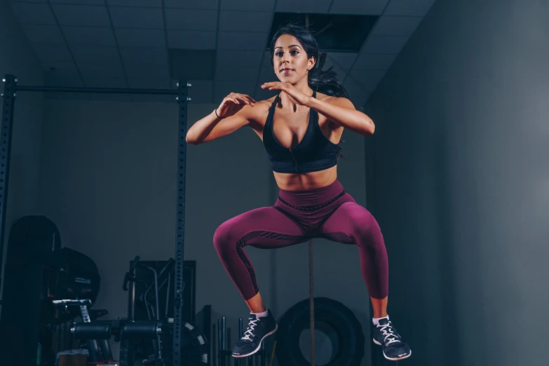 a woman is doing an aerial rope exercise