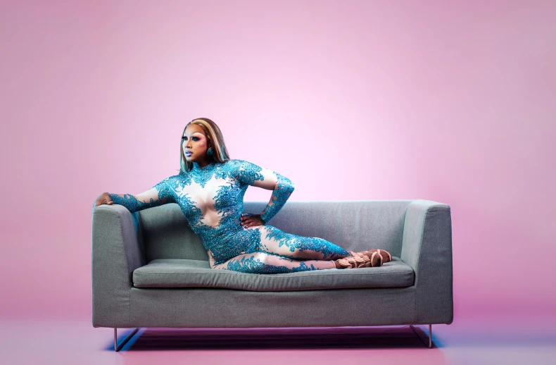 woman sitting on a couch in a blue dress