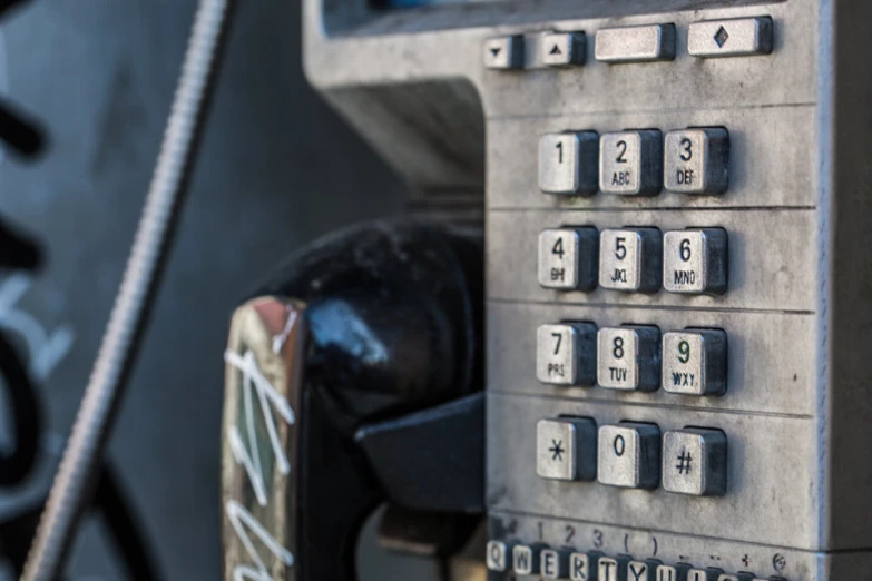 an old pay phone that has been locked up