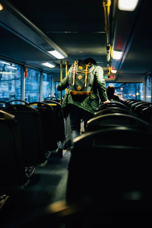 a man is standing on the inside of a bus