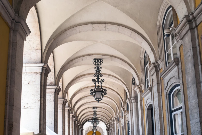 the interior of an old building with arches and lanterns