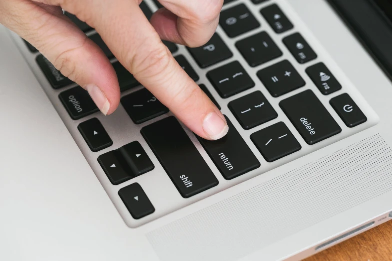 a person with their fingers on a keyboard