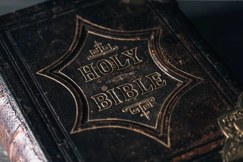 a large bible cover on top of a wooden table