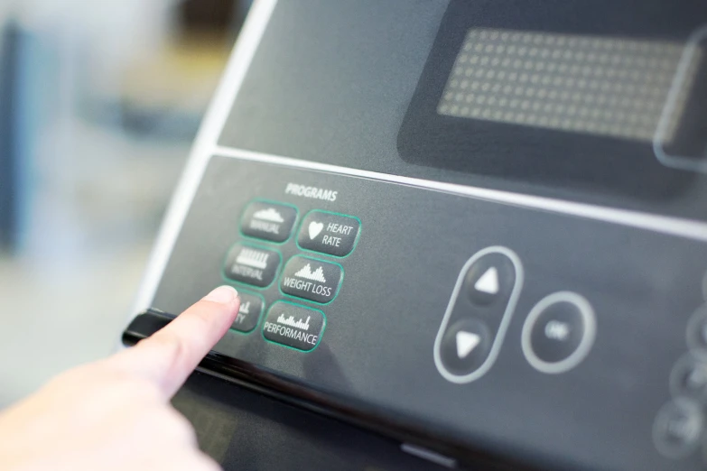 a person that is pressing the ons on a microwave