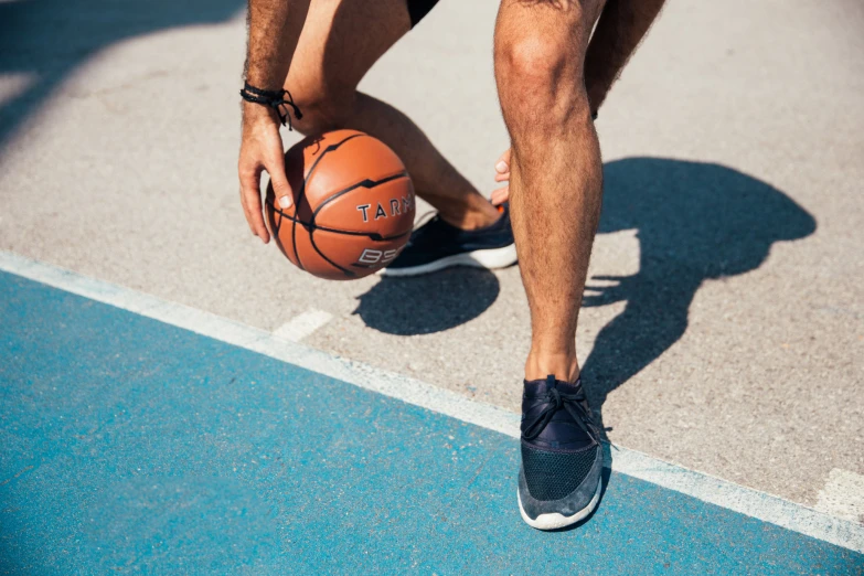 a person that is holding a basketball ball