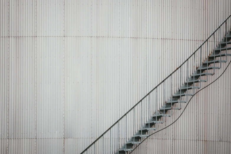 an old set of stairs sits next to an unfinished wall