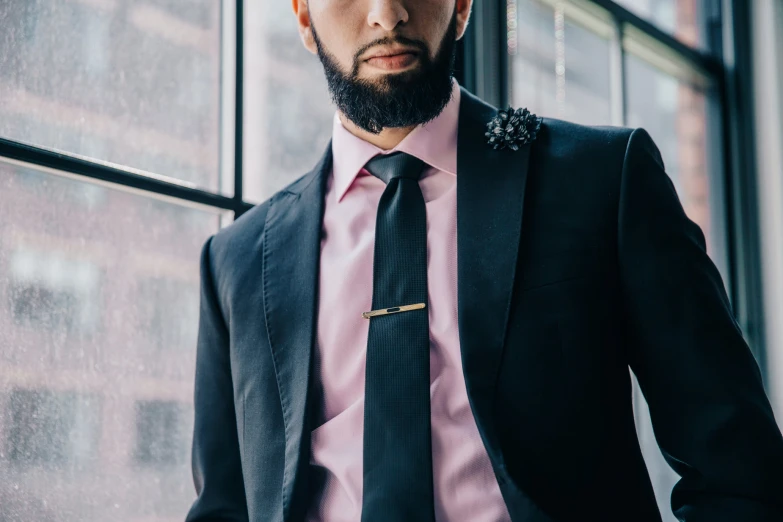 a man with an orange hair and beard wearing a suit