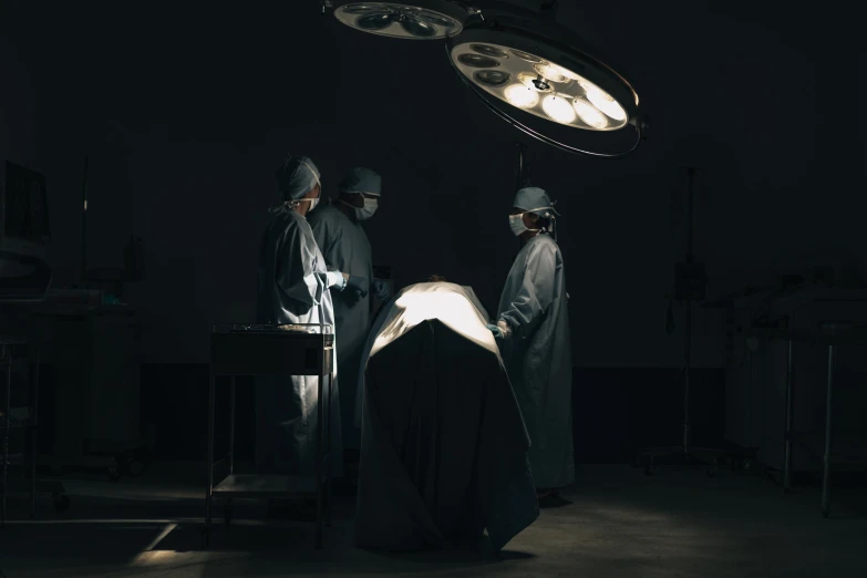 doctors operating in a hospital with bright lights