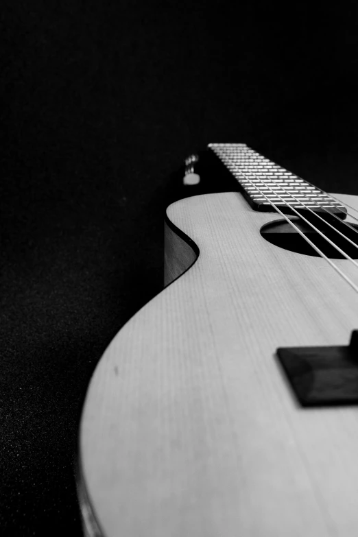 an acoustic guitar that is white and has strings