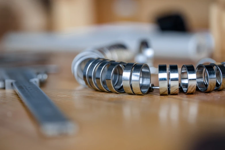 several metal pipes with different types and designs on top of wooden flooring