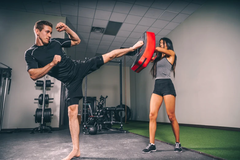 the man and woman are practicing martial moves