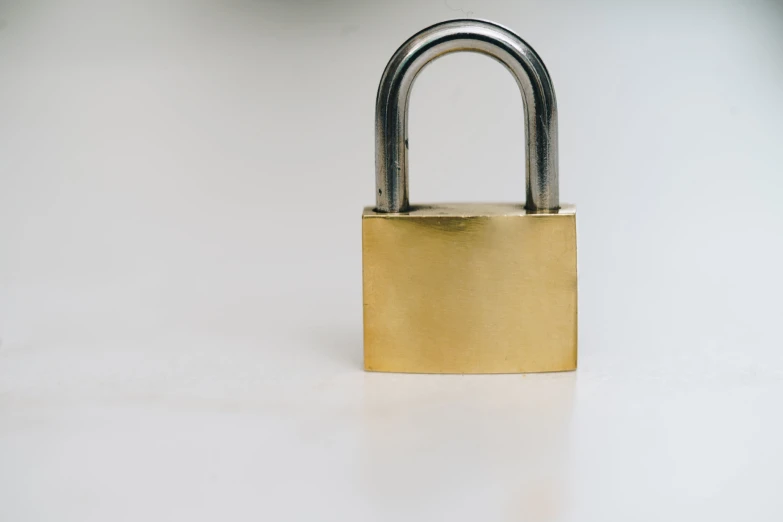 an open padlock on a white surface