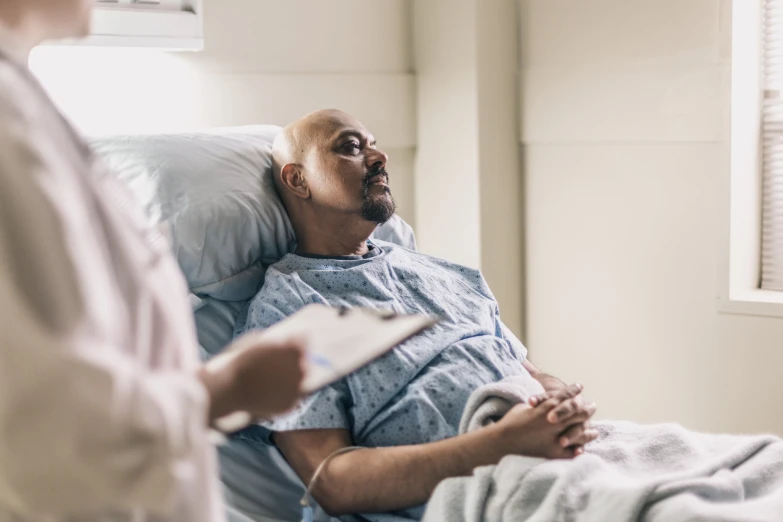 a man in the hospital being tended to by his doctor