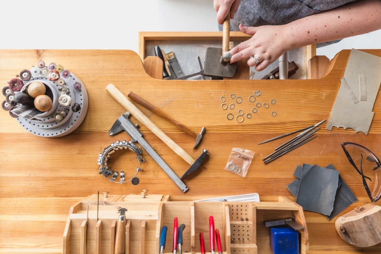 a woman working on soing next to her wooden table