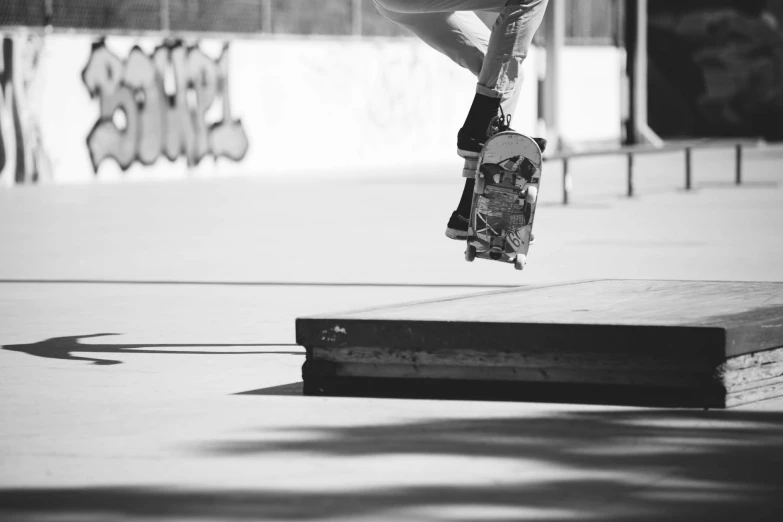black and white image of skateboarder doing a stunt